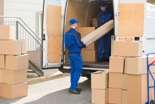 Moving boxes and furniture being prepared for a removals service in Swisscottage