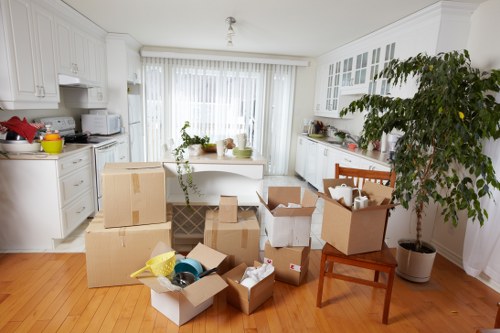 Professional movers packing household items for a local relocation