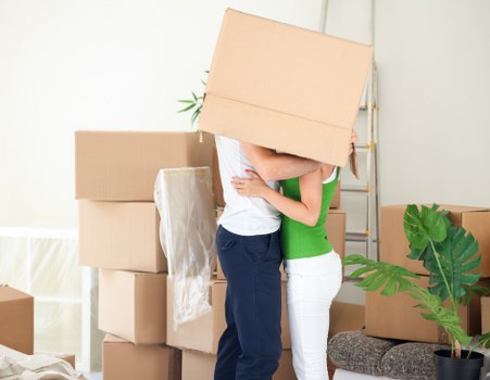 Trained movers using protective equipment during a house move