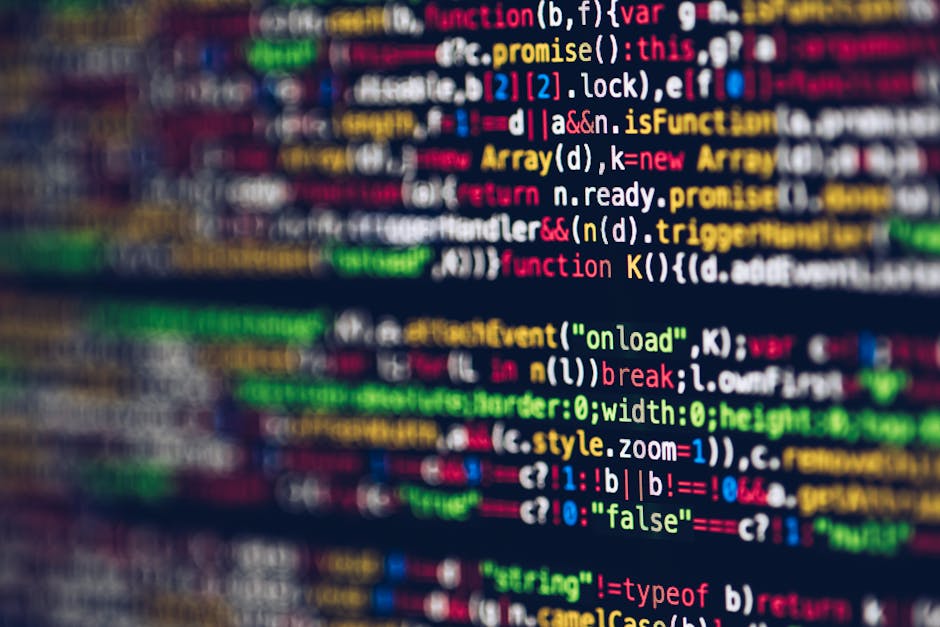 Close-up image of a computer screen displaying colorful lines of code with syntax highlighting, including keywords, variables, functions, and operators in various colors such as red, green, yellow, an